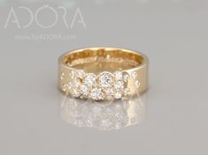 a yellow gold ring with three diamonds on it