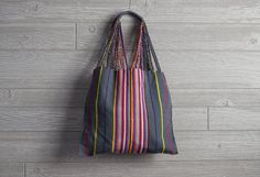 Handwoven With Love These versatile totes are handwoven by artisans in Chiapas, Mexico, on a backstrap loom. Perfect for the farmer's market, a day at the pool or beach, or as an everyday purse! Each bag has vibrant stripes of color which carry on to the straps which are then intertwined with the base color of the bag. The tops of the straps are double wrapped to provide strength and comfort for your shoulder or your hands. How They Are Made The backstrap loom is a traditional style of looming i Striped Woven Rectangular Shoulder Bag, Rectangular Striped Woven Shoulder Bag, Striped Rectangular Beach Bag For Everyday Use, Striped Woven Travel Bag, Woven Striped Travel Bag, Striped Woven Rectangular Beach Bag, Striped Woven Bags For Daily Use, Striped Woven Tote Beach Bag, Striped Woven Beach Bag For Everyday Use