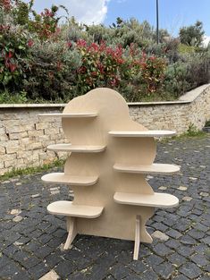 a wooden shelf sitting on top of a cobblestone road