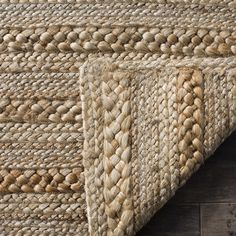 an area rug is shown on the floor with wood floors and dark brown wooden planks