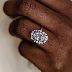 a woman's hand with a diamond ring on it