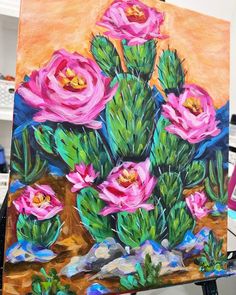 a painting of pink flowers on an easel