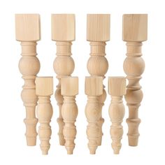 four wooden dowels are lined up on a white background