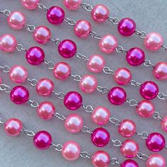 "This fun pink glass pearl chain has a bright look that would be wonderful for all of your vintage designs. This chain features glowing glass pearls in fabulous pinks and fuchsias. As a jewelry designer and wearer, sometimes you need a pink pearl chain that will go with everything! Pair this chain with striking pendants or wear it long and layered for a lovely shabby look. This specialty beaded chain is made with 8mm round glass pearls. The wire links are made of a base metal alloy that has been Pink Pearl Jewelry With 8mm Beads, Pink Pearl Chain Jewelry With Round Beads, Pink 8mm Beaded Necklace, Pink Necklaces With 8mm Beads, Pink Pearl Chain For Jewelry Making, Pink Pearl Necklace, Shabby Look, Jewelry Chain, Rhinestone Cross