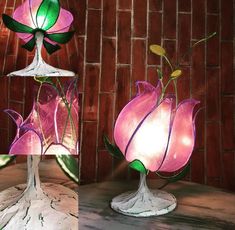 three different views of a flower lamp on a table with brick wall in the background