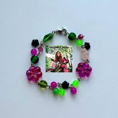 this handmade bracelet is inspired by "femininomenon" by chappell roan! featuring glass beads and czech glass beads in pink and green! the bracelet measures approx 7.5". Green Beaded Chain Bracelet For Gift, Pink Czech Glass Bracelets With Colorful Beads, Bohemian Pink Beaded Bracelets Czech Glass, Bohemian Pink Beaded Bracelets From Czech Glass, Pink Bohemian Beaded Bracelets In Czech Glass, Adjustable Whimsical Green Bracelets, Whimsical Adjustable Green Bracelets, Trendy Green Beaded Chain Bracelet, Trendy Green Beaded Bracelet