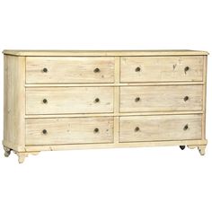 a white wooden dresser with six drawers