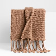 two brown knitted towels folded on top of each other