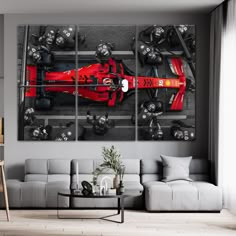 a modern living room with a red race car on the wall and grey couches