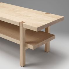 a wooden table with two shelves on each side and one shelf below the table top