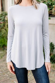 This classic top won't let you down! It's simplistic versatility gives you so much freedom to style it! The comfy fit also makes is a dream to wear! You really can't go wrong with this long sleeve top! This top features long sleeves, a round neckline, and a classic fit. Material has generous amount of stretch.Cam is wearing the small. Versatile Solid Color Tops For Loungewear, Solid Color Long Sleeve Top With Thumbholes For Fall, Long Sleeve Top With Thumbholes, Versatile Long Sleeve Top For Fall, Versatile Long Sleeve Top For Everyday Fall Wear, Simple Long Sleeve Tops For Everyday, Casual Solid Color Long Sleeve Top For Everyday, Effortless Long Sleeve Tops For Casual Gatherings, Casual Long Sleeve Top For Everyday