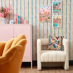 a living room filled with furniture and colorful wallpaper