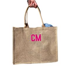 a person holding a bag with the word cm on it