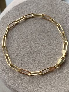 Statement piece for your wrist stack. Features oval-shaped elongated paper link design. Handcrafted in 14K Gold. This beauty is perfect for layering! Makes the perfect gift that will last a life time! 7 inches Solid 14K Gold. 5.5 grams. All our items have been fully inspected for authenticity and condition by a GIA Graduate Gemologist. To see more carefully selected Vintage Bracelets and Watches from Gold Adore, please visit: https://www.etsy.com/shop/GoldAdore?section_id=10797490&ref=shopse Formal Gold Chain Paperclip Bracelet With Oval Link, Yellow Gold Paperclip Bracelet With Oval Link Box Chain, Yellow Gold Paperclip Bracelet With Oval Link, Luxury 14k Gold Paperclip Bracelet With Rectangular Links, Luxury Paperclip Bracelet With Oval Link For Everyday, Formal Oval Link Paperclip Chain Bracelet, Luxury Bracelets With Paperclip Chain, Luxury Paperclip Link Bracelet With Box Chain, Luxury Box Chain Link Paperclip Bracelet