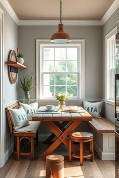 Cozy breakfast nook with wooden table and chairs, decorated with "RAYA" pillows, a vase of flowers, and natural light from the window. Rustic Farmhouse Kitchen Backsplash, Shiplap Walls