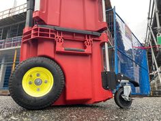 a large red and yellow container sitting on top of a parking lot