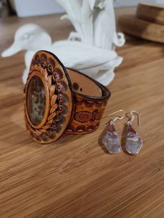 45x30x7mm Red River Jasper Cabochon  2 45 inch wide at center top Taper to 1 inch at closure Red River Earrings with Sterling Sliver Hooks hanging 1.45 inch  Hand made from pattern to tooling  #Find more of my rustic hand made designs https://www.etsy.com/shop/KCsDesignsShop Message for coupons and sale codes if you can't find them on-site. This Cuff is worn loosely fitting size 7 to 8 inch wrist. Size 9 upon request Western Style Cuff Jewelry For Gift, Southwestern Style Adjustable Rectangular Jewelry, Artisan Leather Jewelry, Vintage Hand-tooled Cuff Jewelry, Unique Hand Tooled Jewelry, Unique Brown Cuff Jewelry, Vintage Leather Jewelry With Concho, Hand Tooled Brown Cuff Jewelry, Handmade Leather Cuff Jewelry