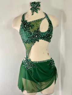 a woman's green and white belly dance costume with beading on the bust