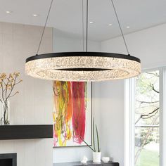 a modern chandelier hangs over a dining room table