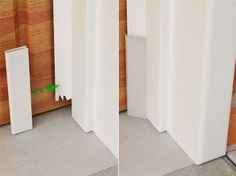 there are two tall white poles next to each other on the floor in front of a wood paneled wall