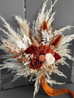 a bridal bouquet with red and white flowers