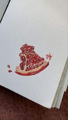 a piece of pizza with pomegranates on it sitting on top of a table