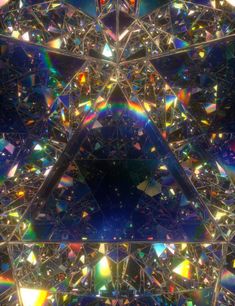 an abstract image with many colors and shapes in the center, as well as triangles