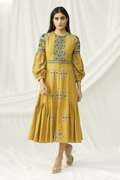 Mustard yellow flared midi dress with all-over geometric, floral motif resham work and pleated sides.
Components: 1
Fabric: Kala Cotton
Neckline: Round
Sleeve Length: Three Quarter
Color: Yellow
Embroidered
Balloon cuff sleeves
Pleated sides
Closure: Front loop buttons - Aza Fashions Resham Work, Midi Dress For Women, Cotton Midi Dress, Indian Design, Womens Midi Dresses, Dress For Women, Cuff Sleeves, Aza Fashion, Mustard Yellow