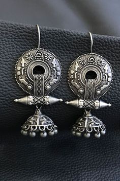 Our Rabari Earrings are handmade by artisans in Gujarat, India using brass with silver finish in an artistic tribal design from this region. Our fair trade earrings are are made with high quality materials and come in a range of beautiful designs, and showcase the fine metal craft traditions of India. Traditional Silver Metal Earrings, Traditional Artistic Design Earrings For Festivals, Bohemian Jhumkas With Intricate Design, Traditional Earrings With Artistic Design For Festivals, Silver Hoop Earrings With Intricate Design, Metal Earrings With Intricate Design For Festivals, Silver Brass Hoop Earrings With Intricate Design, Traditional Artistic Design Drop Earrings, Ornate Chandbali Earrings For Festival