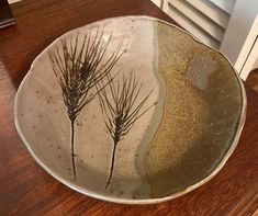 a plate with some plants in it on a table