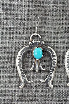 These turquoise and sterling silver earrings were made by Navajo silversmiths Eva & Linberg Billah. The backs are signed EL and stamped sterling.Length: 1 7/8"Width: 1 1/8"Free shipping on all orders! We ship with USPS and always include tracking. All orders ship within a day of payment.Returns are accepted up to 30 days after you receive your order. Just send us a message. Our shop offers cash back or store credit. The item must be returned in new condition. Western Style Dangle Earrings For Pierced Ears, Western Turquoise Dangle Earrings, Turquoise Dangle Earrings Western Style, Handmade Western Turquoise Earrings, Western Style Nickel-free Turquoise Earrings, Turquoise Nickel-free Western Earrings, Western Turquoise Nickel-free Earrings, Western Style Turquoise Nickel-free Earrings, Silver Dangle Western Earrings