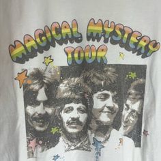 a white t - shirt with an image of the band's faces on it