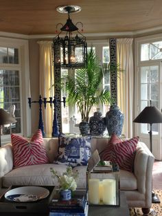 a living room filled with furniture and lots of windows