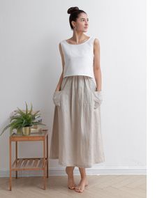 "★★FEATURES 100% Linen  Two big pockets Plus size Linen skirt A Line skirt Casual Linen skirt Perfect for Summer, Spring, Autumn ★★ Model Size Height approx 172 cm (5′ 8″)  Bust 84 cm (33\")  Waist 66 cm (26\")  She wears size XS. ★★ Bespoke Order Service If you Request other color Request the length Your height is not between 155 cm- 172 cm Your weight is over 75 kg I can do it for you, It will need some extra fee depending on on your need. Contact with me for more detail. ★★ Warmly Note: 1 ) : Casual Beige Midi Skirt, Casual Full Skirt In Beige, Casual Beige Full Skirt, Casual Beige Full Skirt Bottoms, White Full Skirt With Pockets, Casual Long Beige Skirt, White Long Skirt With Pockets, Beige Flared Skirt With Pockets, Beige Relaxed Skirt With Pockets