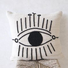 a pillow with an eye drawn on it