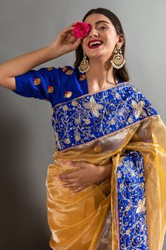 Yellow saree with an woven solid base highlighted by blue sequin aari embroidered butterflies and flower motifs. Comes with contrast embroidered blouse.
Components: 2
Pattern: Embroidered
Type Of Work: Aari, Sequins 
Neckline: Round
Sleeve Type: Half
Fabric: Tissue
Color: Yellow,Blue
Other Details: 
Heavy border
Placed embroidery
Occasion: Sangeet,Wedding - Aza Fashions Designer Organza Blouse With Dori Work, Organza Blouse With Dori Work For Festivals, Festive Organza Blouse With Dori Work, Festival Organza Blouse With Dori Work, Traditional Organza Blouse Piece With Dori Work, Festive Organza Blouse Piece With Dori Work, Blue Tissue Silk Saree With Dori Work, Traditional Organza Saree With Unstitched Blouse, Traditional Organza Blouse Piece For Navratri