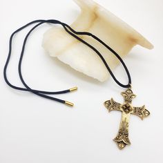 This pendant is a reproduction of a 19th century cross derived from crosses worn by soldiers in the Crusades of the 11th-13th centuries. This beautiful necklace has a nice weight and is comfortable to wear. Materials: Pewter with antique gold plating and a 28" cotton cord Pendant size: 1.75" wide and 2.5 inches long Made in USA Sales from this jewelry go to support The Art Institute of Chicago. Traditional Gold Crucifix Jewelry, Vintage Adjustable Cross Pendant Necklace, Adjustable Vintage Cross Pendant Necklace, Spiritual Metal Cross Necklace, Vintage Metal Cross Pendant Necklace, Vintage Metal Crucifix Cross Necklace, Bronze Crucifix Necklace For Spiritual Purposes, Spiritual Metal Pendant Cross Necklace, Spiritual Metal Cross Pendant Necklace