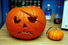 a carved pumpkin sitting on top of a wooden table