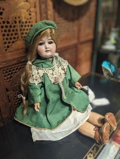 a doll sitting on top of a table next to a mirror