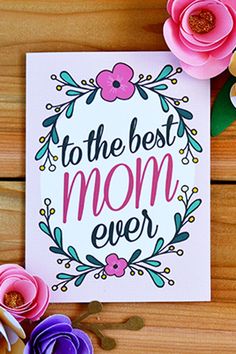 the best mom ever card with flowers and paper flowers around it on a wooden surface