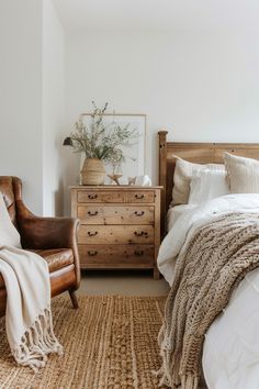 a bedroom with a bed, chair and dresser in it's centerpieces