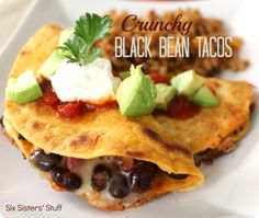 two black bean tacos on a white plate