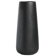 a black vase sitting on top of a white table