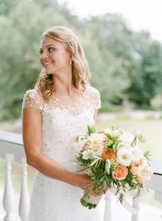 a woman in a wedding dress holding a bouquet