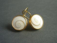 "Timeless and stylish, these pretty earrings are beautiful for daytime as well as evening wear. In their simplicity, these earrings make a sculptural, contemporary statement. A pair of slightly domed operculum shells are bezel set in a combination of 22-karat gold and 18-karat gold. The gold has a matte/brushed finish. These hand made earrings measure about 1/2\" in diameter and 7/8\" from top of the ear wire to the bottom of the earrings. In millimeters, the earrings measure about 13 mm in diam 22k Gold Earrings, Golden Spiral, Earrings Golden, Swirl Earrings, Golden Ratio, Spiral Earrings, Pretty Earrings, How To Make Earrings, 22k Gold