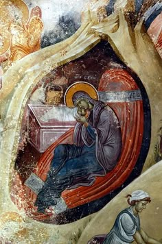 an icon depicting jesus in the center of a cave with other people around him and one kneeling down