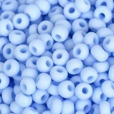 many white beads are scattered together on a blue surface