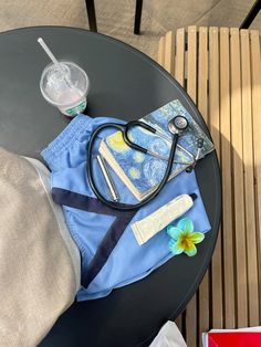 a doctor's stethoscope and other medical supplies sit on a table