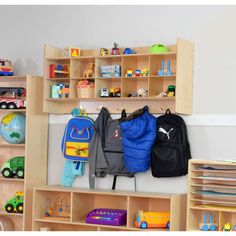 a child's room with toys and bookshelves on the wall, including backpacks