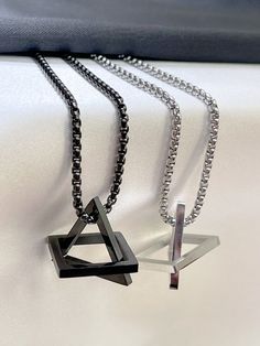 Interlocking Triangle Square Pendant Necklace, Geometric Stacking, Silver, black interlock necklace, triangle necklace~ Materials :  silver and black  (stainless steel chain)~ Style :  necklace~ Length : can make a specific length if you want.~ Can also be made to a bracelet pls message if you want a braceletThe necklace we have 18, 20, 22 , 24, 26 or 30 inches. Please pick a size.We have 2 pendant sizes 4 cm and 4.5 cm please let us know which one you would like ALL SHIPPING COMES WITH TRACKING Black Stainless Steel Chain Necklace, Minimalist Black Chain Necklace With Silver Chain, Minimalist Black Chain Necklace With Silver Details, Black Minimalist Necklace With Silver Chain, Minimalist Black Necklace With Silver Chain, Black Metal Necklace With Box Chain, Black Metal Box Chain Necklaces, Minimalist Triangle Metal Necklace, Black Stainless Steel Clavicle Chain Necklace